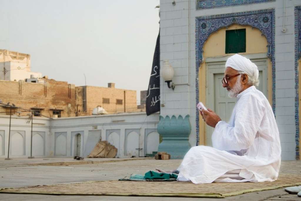 Man reading Muhaf to show the benefits of hafiz quran